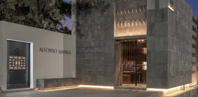 Illuminated entrance and Alfonso Marina sign — open the venue in Google Maps